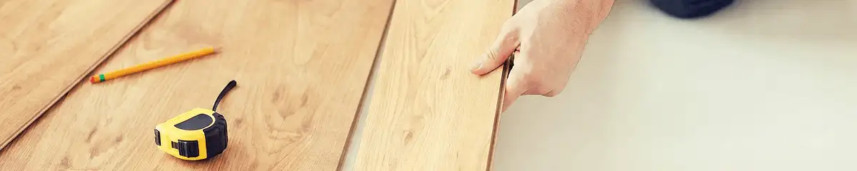 A professional installing wood flooring in Scottsdale, AZ