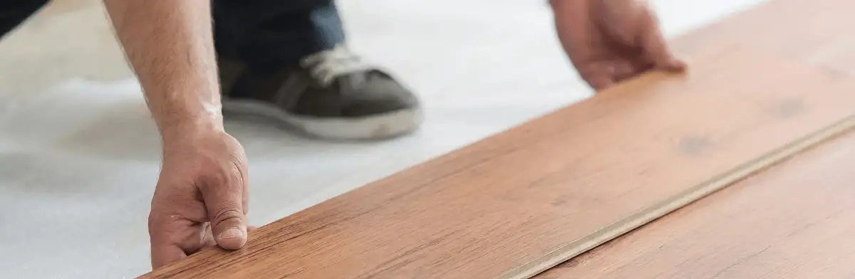 A professional installing laminate flooring in Scottsdale, AZ