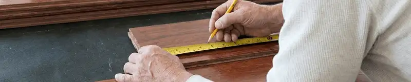 A professional installing wood flooring in Scottsdale, AZ